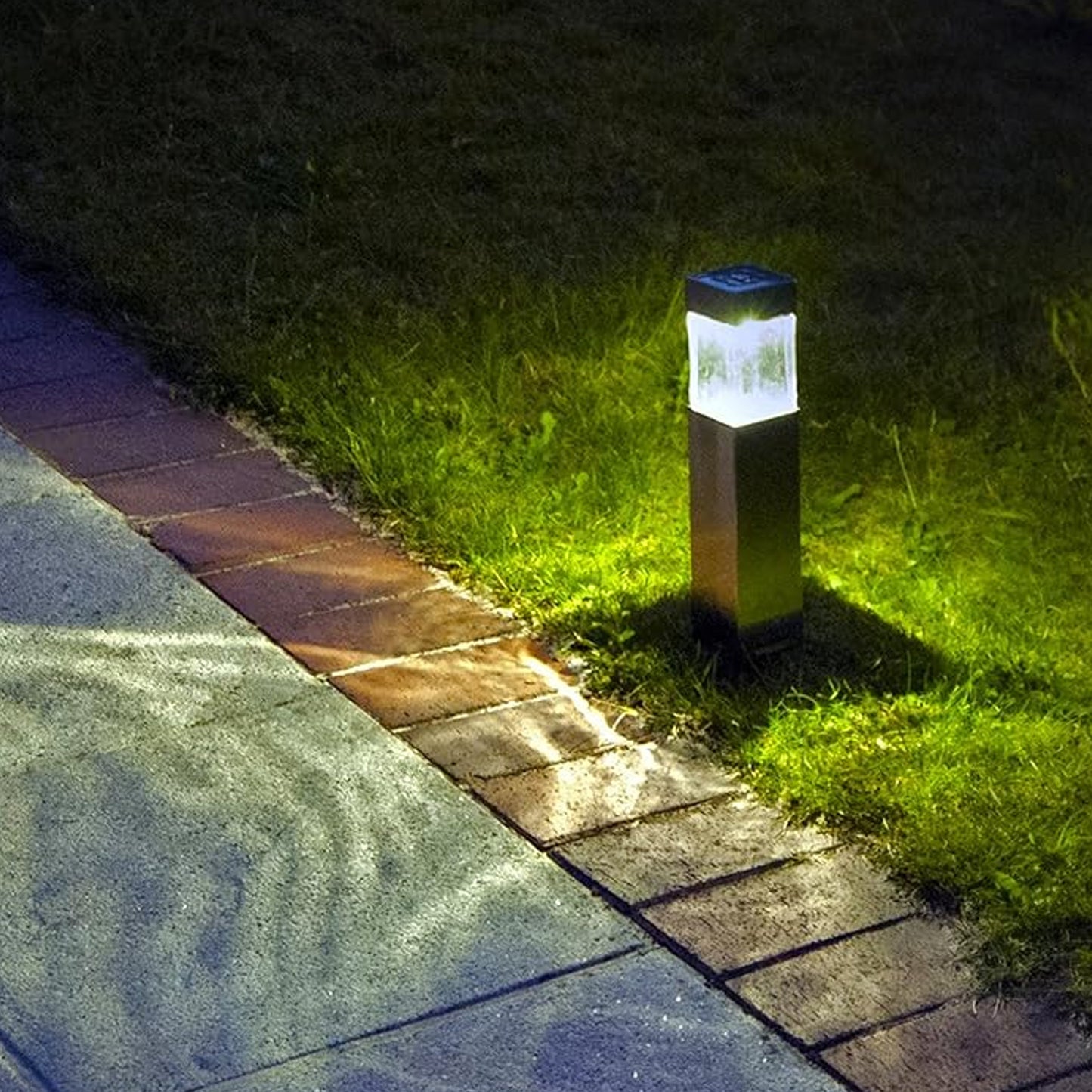 weatherproof solar park lighting bollard illuminating brick edged garden path at night