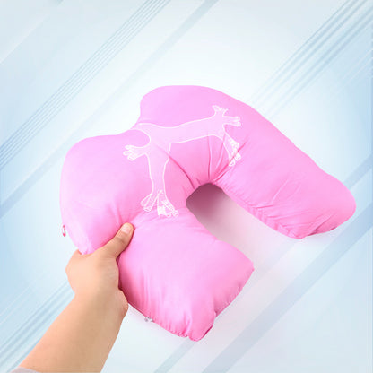 pink U shaped travel neck pillow for airplanes with white lizard print held in hand