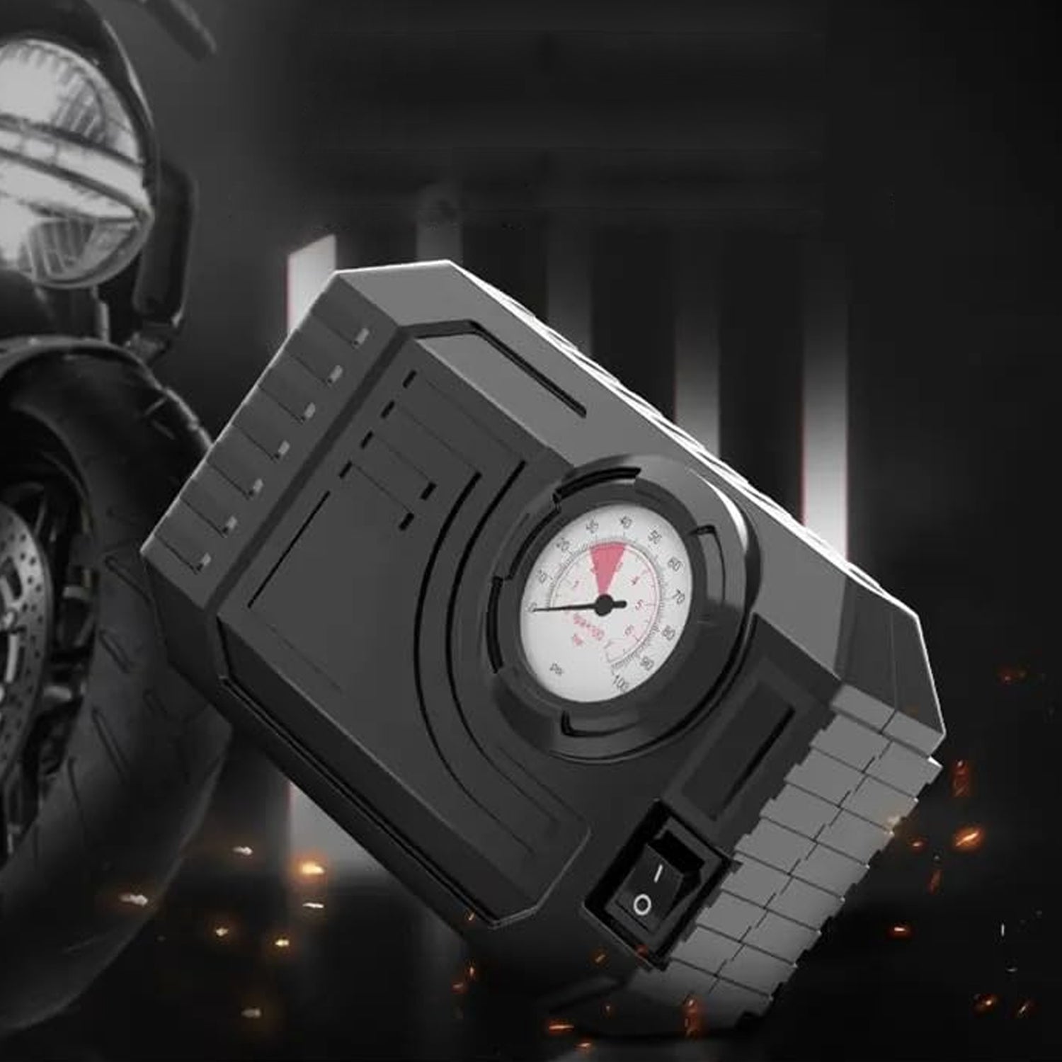 compact black car tire inflator with analog gauge near motorcycle wheel best portable air pump with LED light for cars