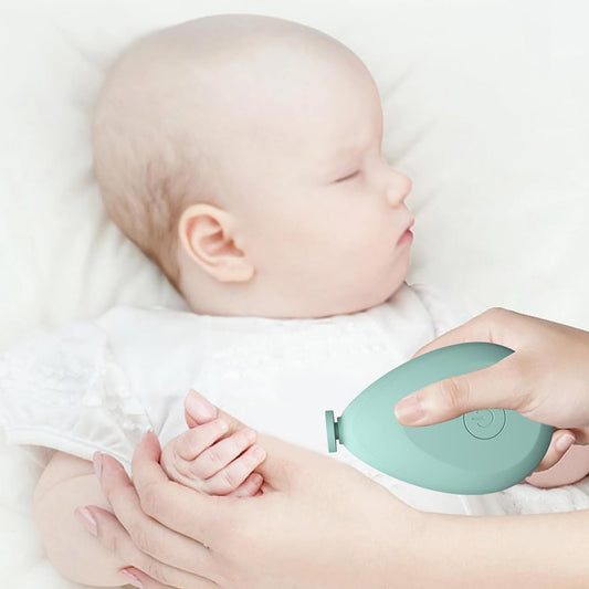 mint green newborn nail grinder with extra heads gently trimming a sleeping babys fingernails