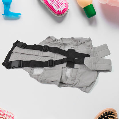 gray baby holder carrier for newborns with adjustable black straps laid flat among baby care items