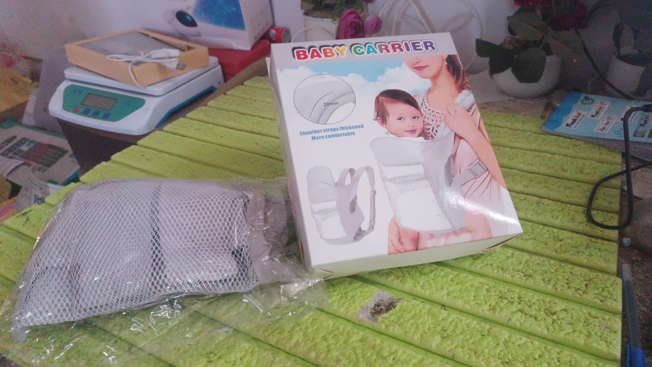 baby holder carrier for newborns retail box showing mother and baby beside mesh insert