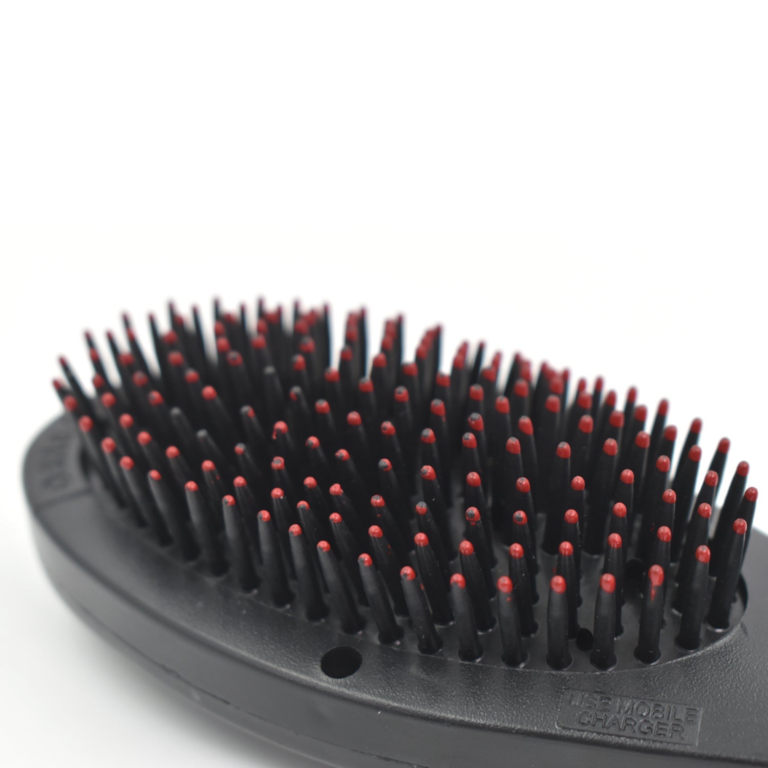 black oval hair brush with massage function featuring dense flexible bristles with red tips