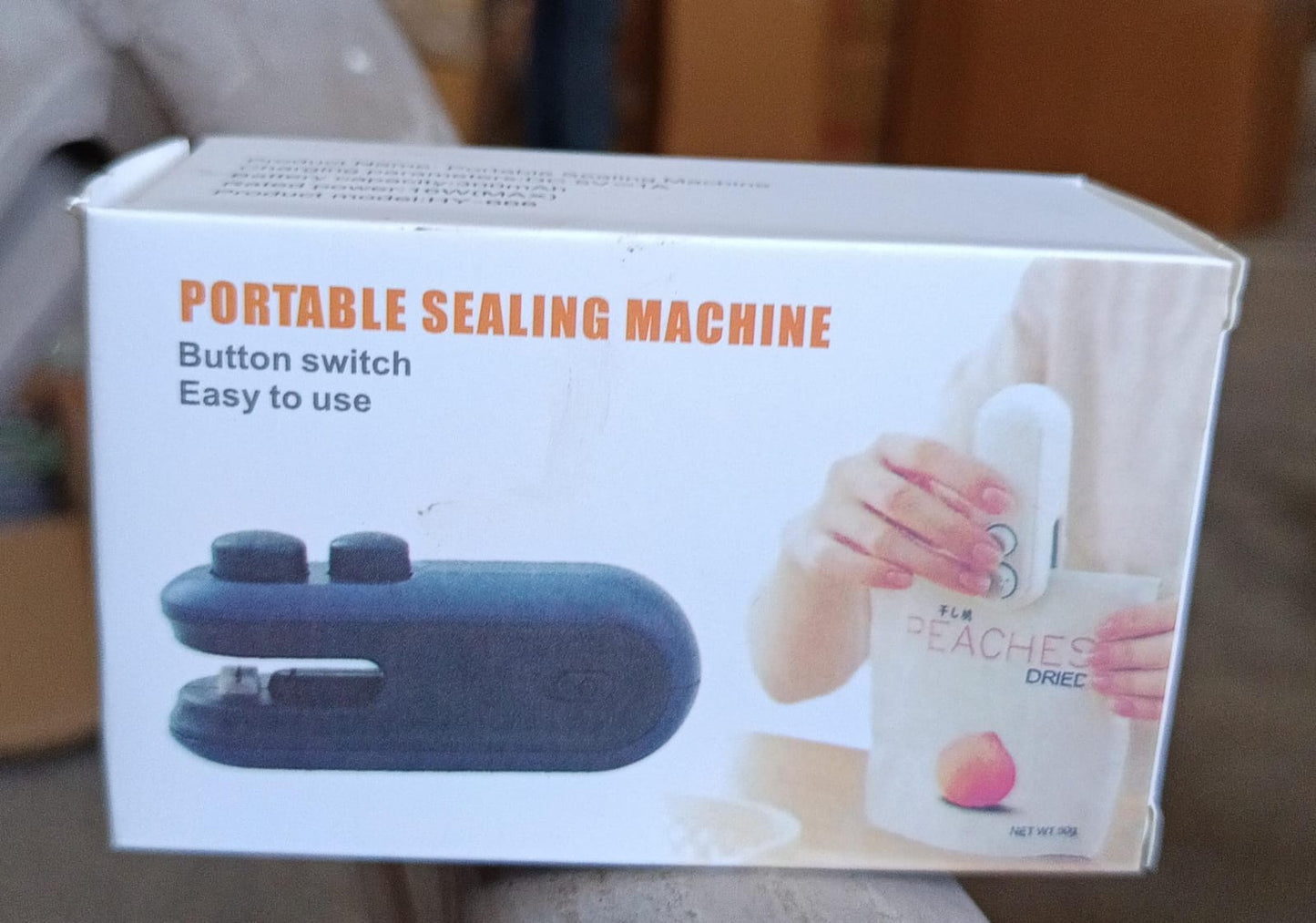 portable heat sealer and cutter handheld sealing machine box showing black sealer and hand sealing snack bag