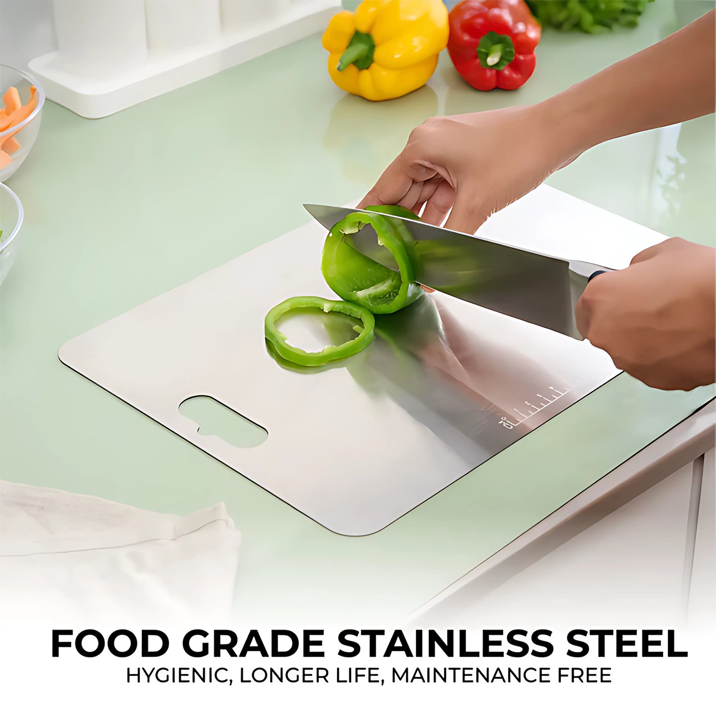 stainless steel chopping board with hands slicing green bell pepper on a clean kitchen countertop