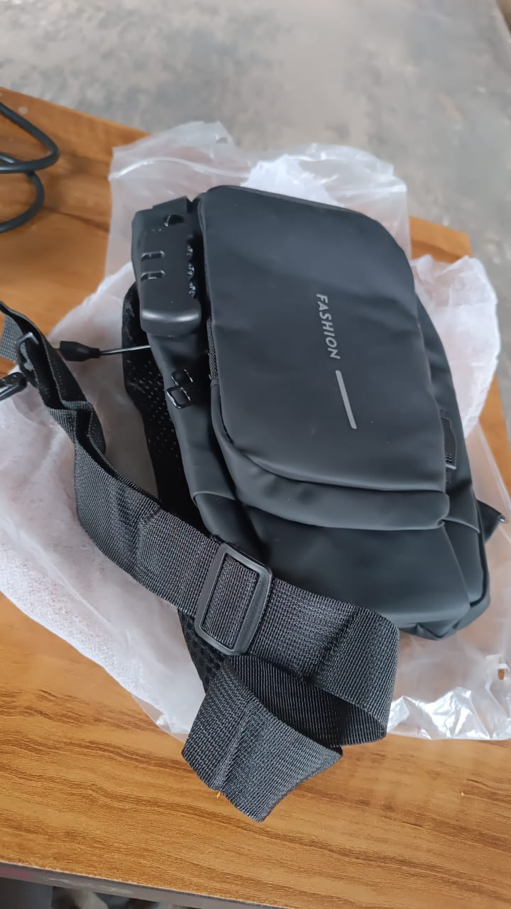 black compact shoulder pouch with adjustable strap and front flap labeled FASHION trendy shoulder bag for travel