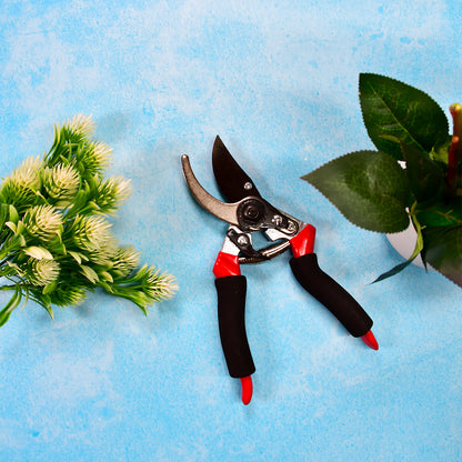 red and black pruning shears on blue background with plants best garden shears for home use