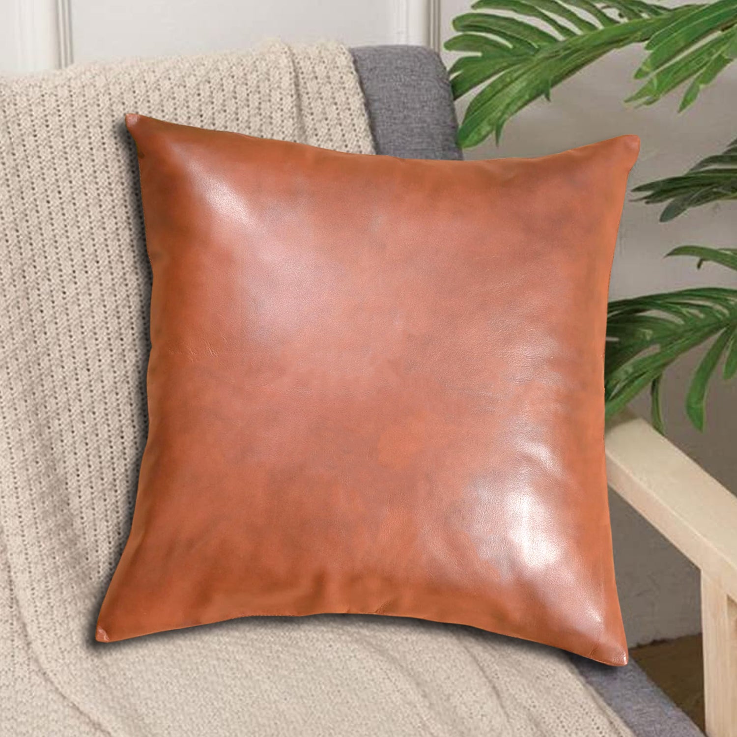 brown faux leather square pillow on sofa displayed with knit throw and plant modern home decor pillowcase