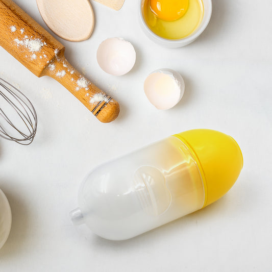 household egg puller gadget clear yellow egg shaped tool on kitchen counter with cracked eggs and rolling pin