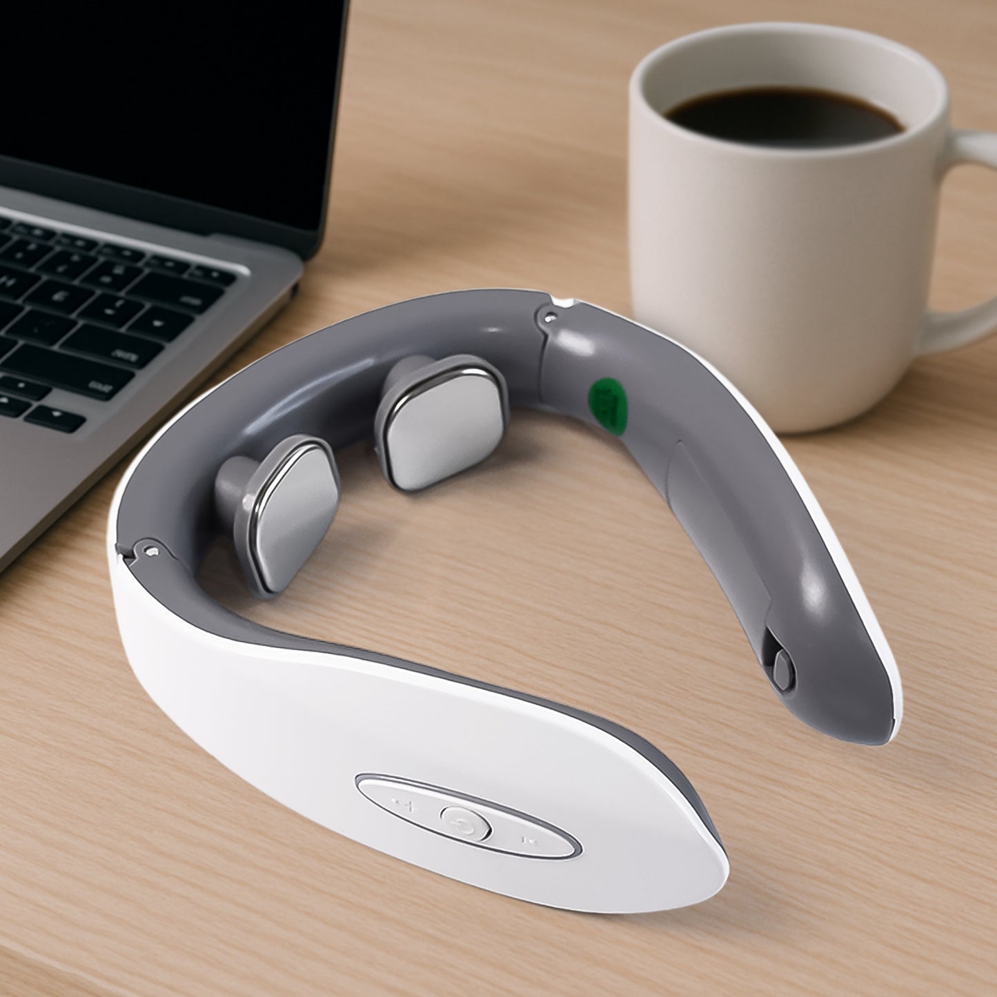 electric neck massager for pain relief in white gray with dual electrode pads on desk near laptop and coffee