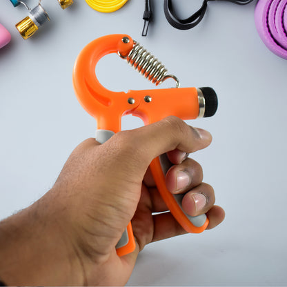 orange hand grip strengthener held in hand with spring mechanism on gym background best grip strengthener for gym