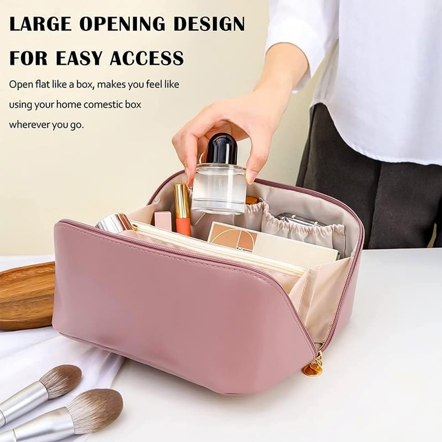 peach travel makeup organizer pouch open on table showing large opening with cosmetics and brush
