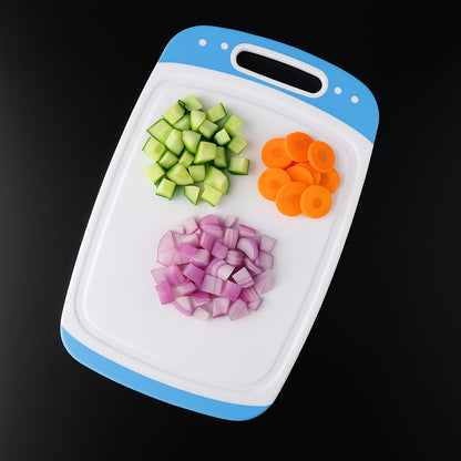 white and blue plastic cutting board with handle and chopped cucumber carrot onion best chopping board for home use