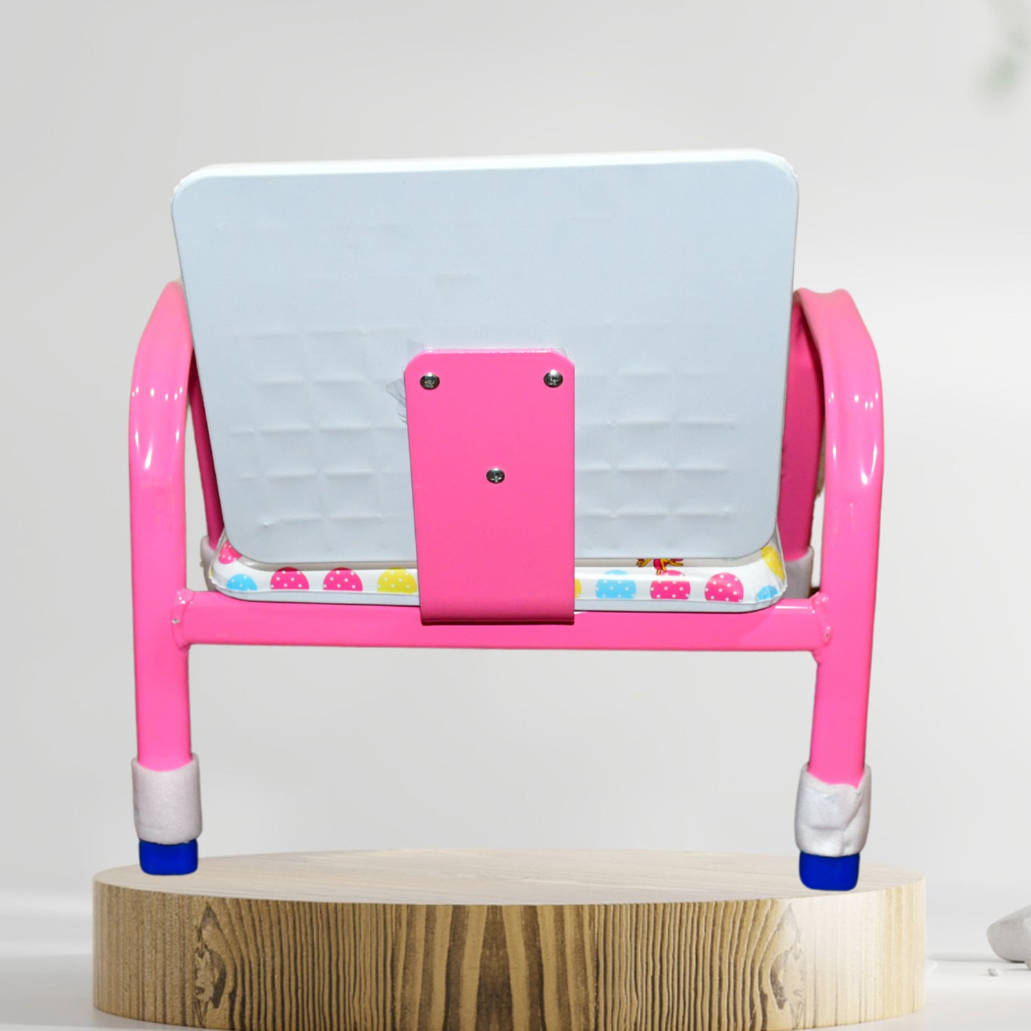 pink cartoon baby chair with steel frame white backrest and patterned seat cushion on wooden display