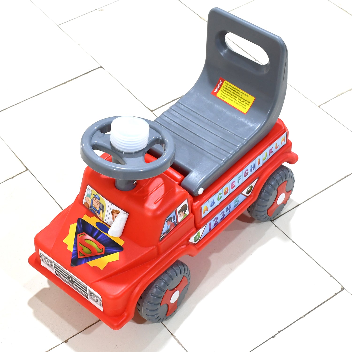 red plastic kids ride on push car with backrest and steering wheel with alphabet stickers