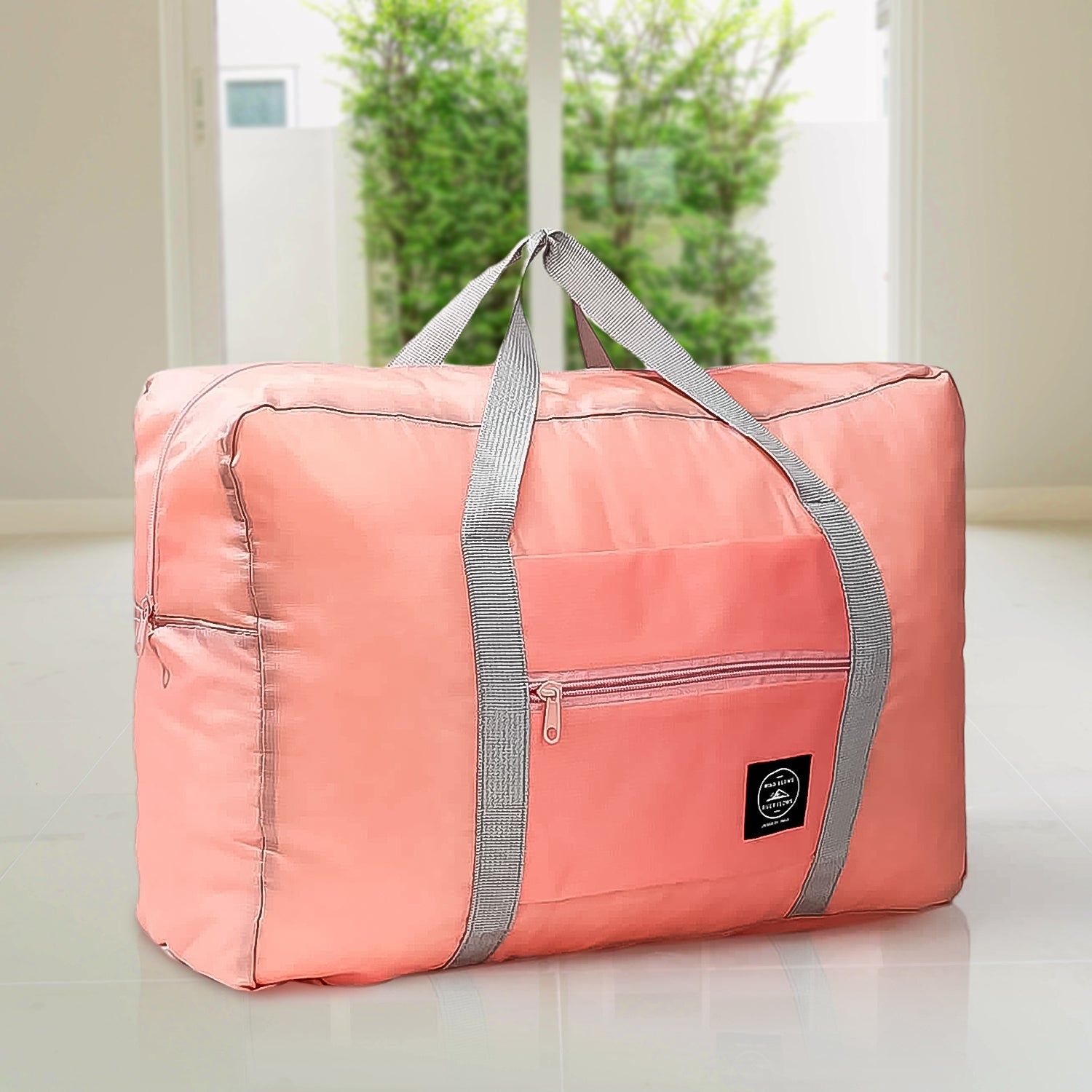 pink foldable duffel with gray straps and front pocket large capacity luggage bag for travel