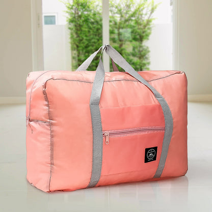 pink foldable duffel with gray straps and front pocket large capacity luggage bag for travel