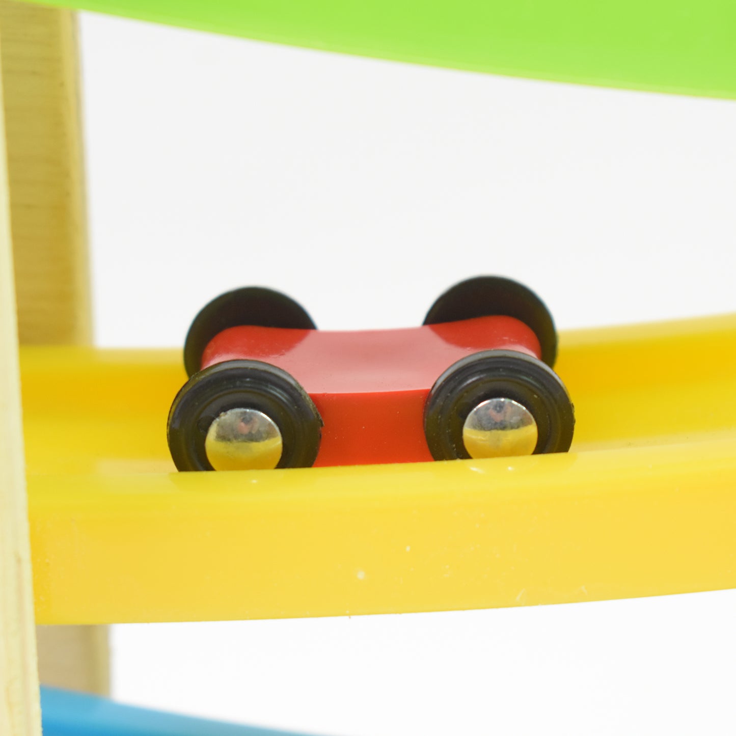wooden car racer track play set with red wooden car and black wheels on yellow spiral ramp