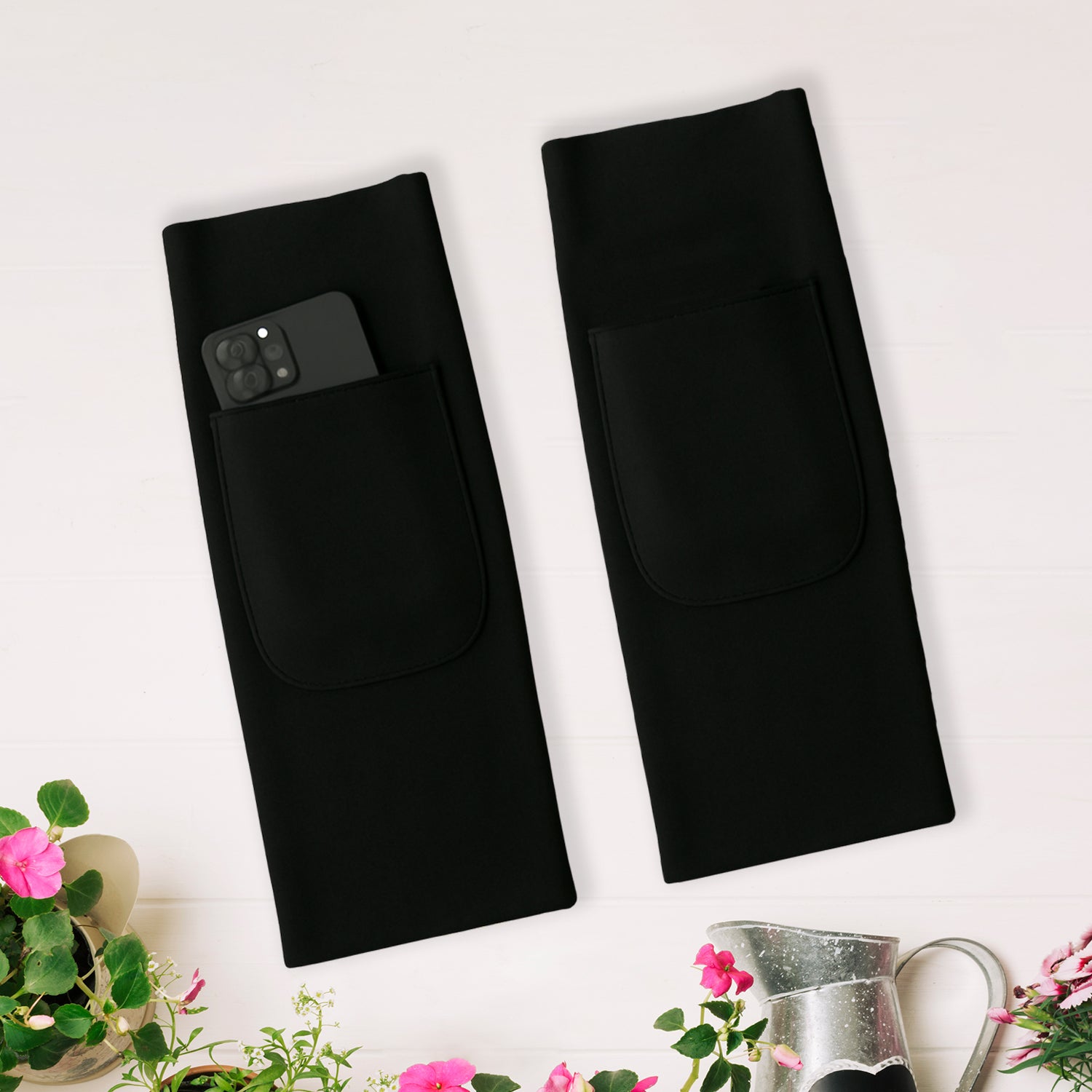 black pair with pocket and phone shown durable arm protection sleeves for gardening and medical use